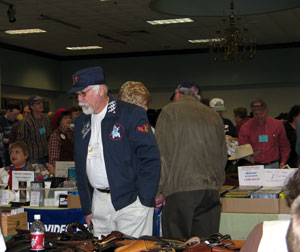 Cadet Jim looks over dealers table.