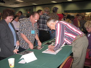 Jan signs pictures for his fans